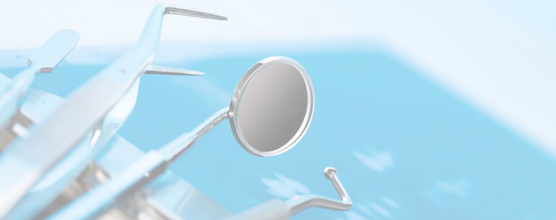 The image features a close-up of a metallic object with a circular hole, set against a blurred background that appears to be an outdoor setting with blue sky and a hint of greenery.