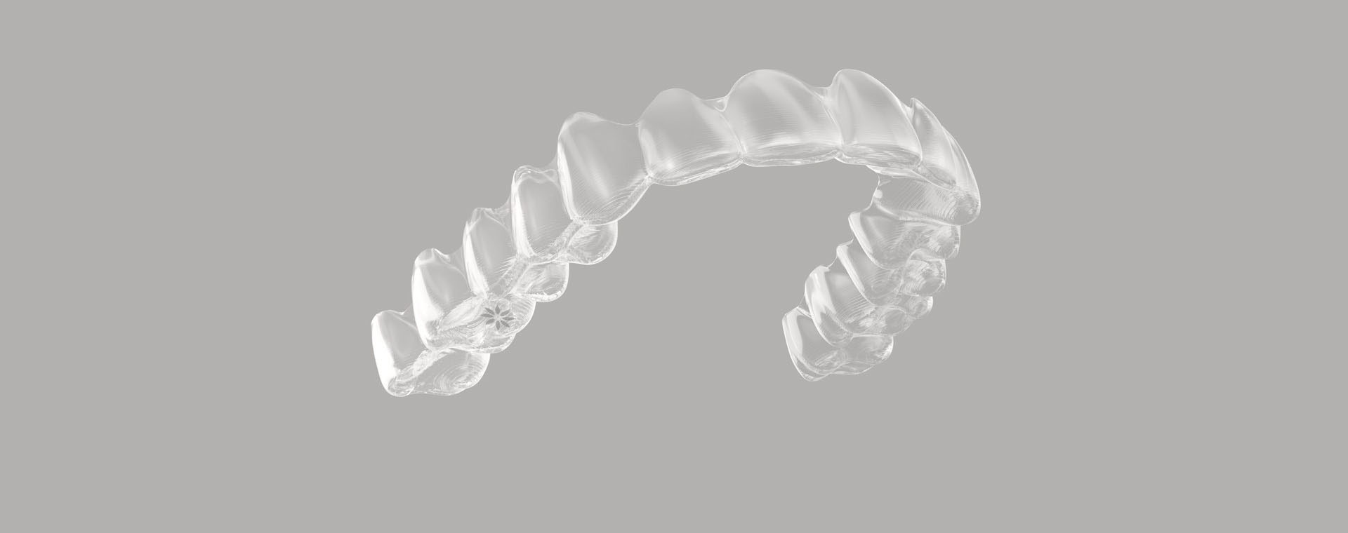 The image shows a transparent, curved object resembling a piece of dental floss floating against a dark background.