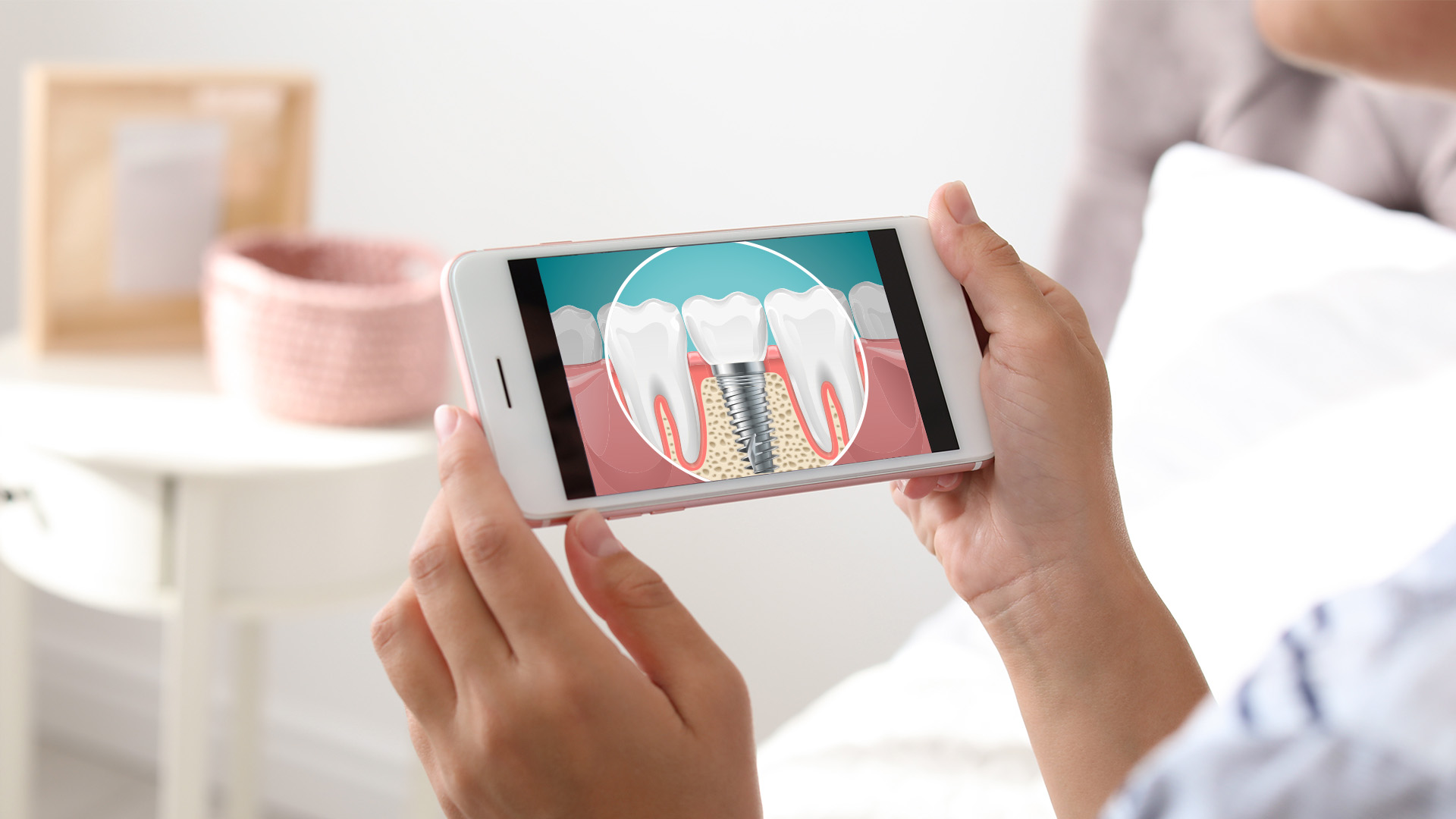 A person holding a smartphone with an app displaying a toothpaste tube and a toothbrush brushing teeth.