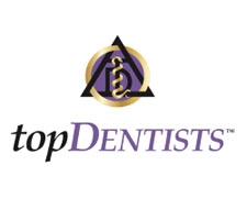 The image shows a logo with a purple background featuring a golden triangle symbol at the top, followed by the text  TOPDENTISTS  in white capital letters. The style of the image suggests it is a digital graphic commonly used for branding or as part of a professional directory.