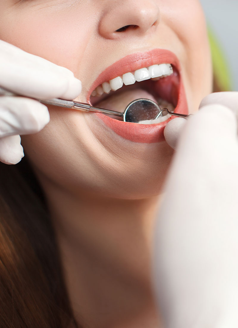 Woman receiving dental treatment with a smiling expression.